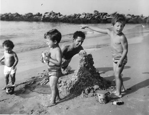 Guthrie family building sandcastles in Coney Island, Brooklyn, NY, 1951. Left to right: Nora, Joady, Woody, and Arlo Guthrie